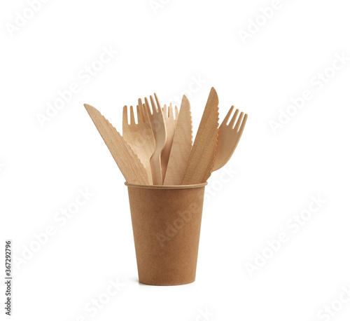 paper cup from brown craft paper and wooden forks and knives isolated on a white background
