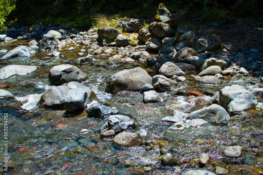 Clear water of a mountain river flowing over rocks Clear water of a mountain river flowing over rocks