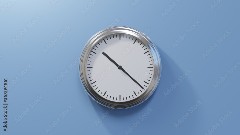 Glossy chrome clock on a blue wall at twenty-two past ten. Time is 10:22 or 22:22 Glossy chrome clock on a blue wall at twenty-two past ten. Time is 10:22 or 22:22