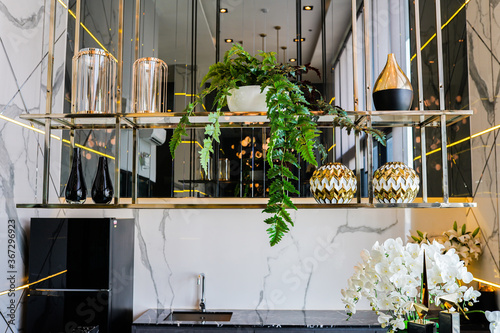 Home decoration and furniture in modern kitchen room in luxury style, interior with marble shelves and mirror decorations