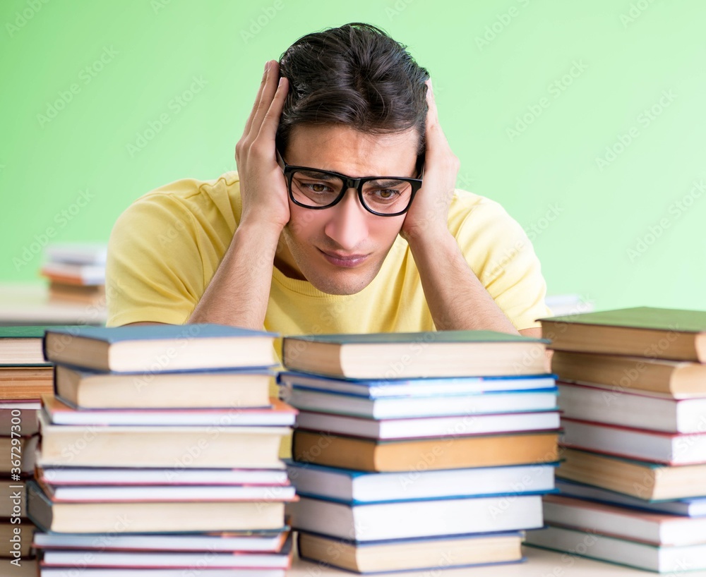 Student with too many books to read before exam Student with too many books to read before exam