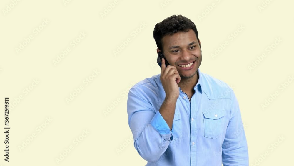 Delighted businessman talking on mobile phone. Excited man celebrating personal success. Isolated on white background. Delighted businessman talking on mobile phone. Excited man celebrating personal success. Isolated on white background.