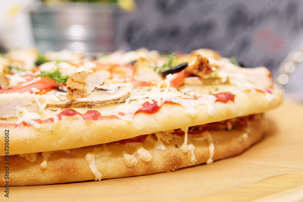 Ready-made pizza with filling on a wooden tray Ready-made pizza with filling on a wooden tray
