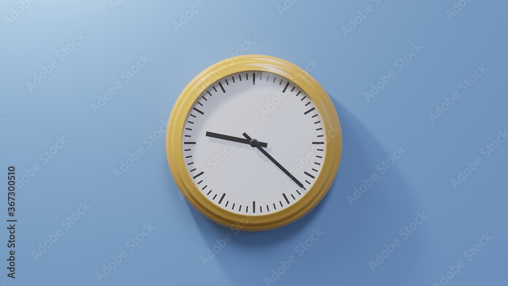 Glossy orange clock on a blue wall at twenty-two past nine. Time is 09:22 or 21:22