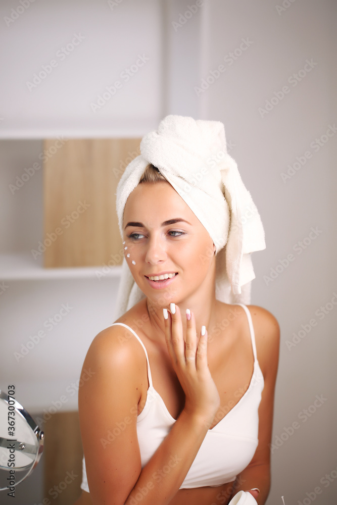 portrait of a beautiful woman applying face cream for skin care portrait of a beautiful woman applying face cream for skin care