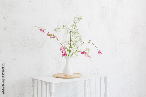 flowers in vase on background white wall