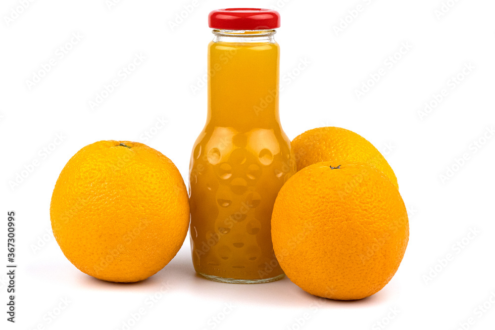 Orange juice bottle. Nearby are beautiful oranges. Orange juice bottle. Nearby are beautiful oranges.