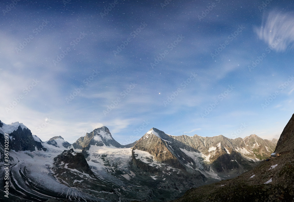 Amazing scenery in evening, beautiful mountains area with white snow. Gorgeous mountain ridge with high rocky peaks Dent Blanche with shining stars in sky, wonderland. Amazing scenery in evening, beautiful mountains area with white snow. Gorgeous mountain ridge with high rocky peaks Dent Blanche with shining stars in sky, wonderland.