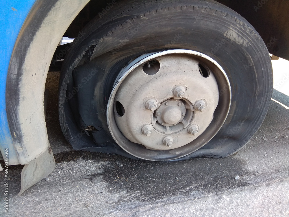 Broken, deflated and damaged car wheel. close up Broken, deflated and damaged car wheel. close up