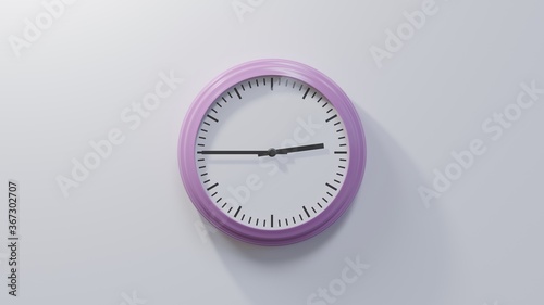 Glossy pink clock on a white wall at quarter to three. Time is 02:45 or 14:45