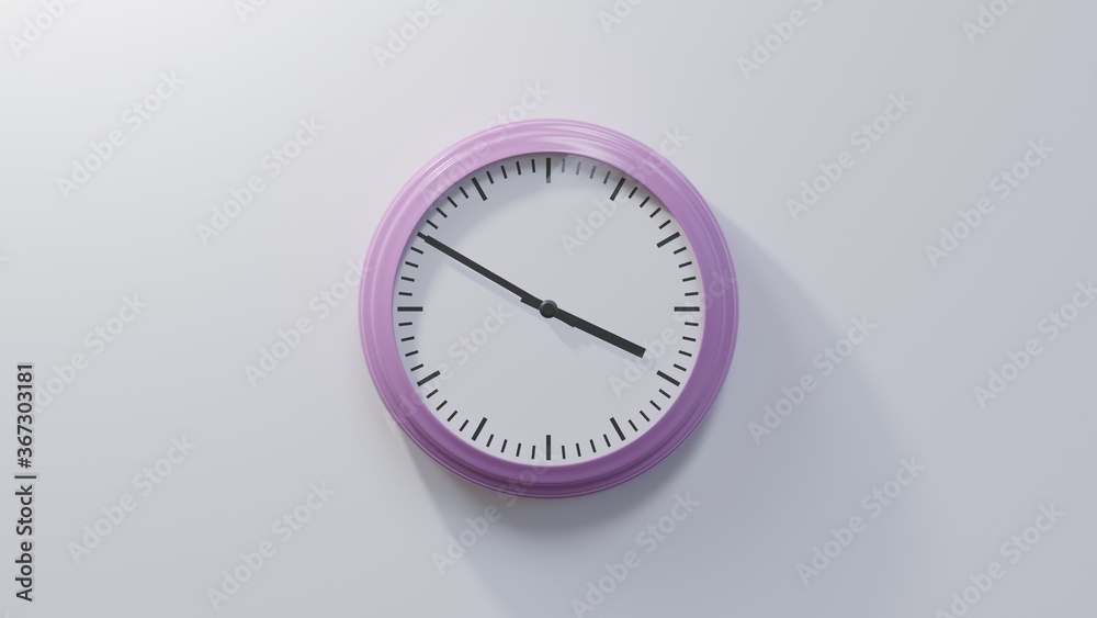 Glossy pink clock on a white wall at ten to four. Time is 03:50 or 15:50 Glossy pink clock on a white wall at ten to four. Time is 03:50 or 15:50