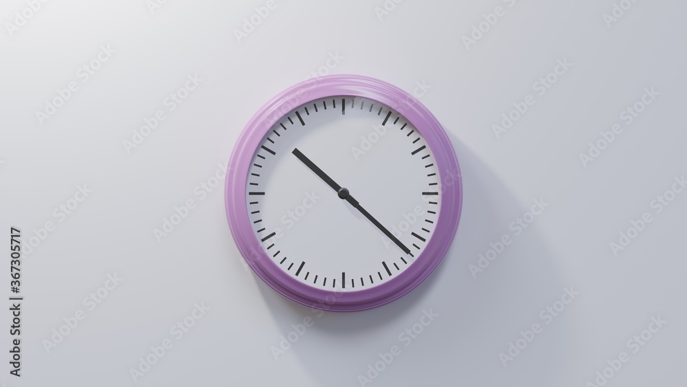 Glossy pink clock on a white wall at twenty-two past ten. Time is 10:22 or 22:22