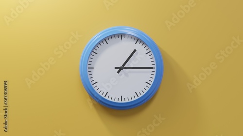 Glossy blue clock on a orange wall at quarter past one. Time is 01:15 or 13:15