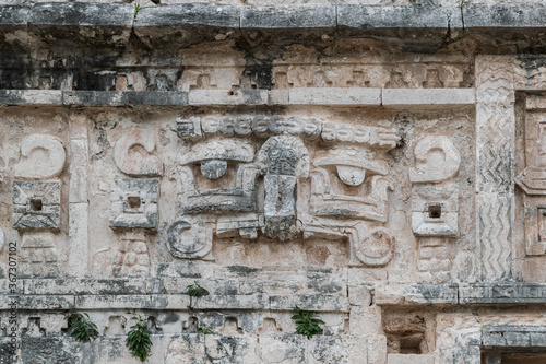 Close-up on the pre-columbian carvings on the walls of one of the building at the Chichen-Itza Mayan site, Mexico.