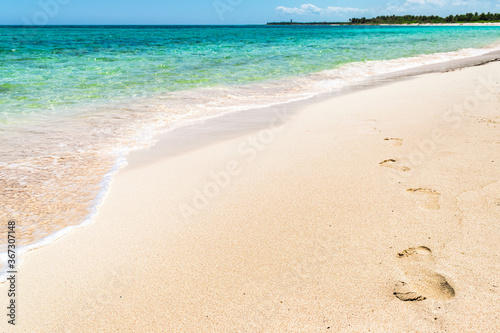 Footprints on the tropical Xcacel beach on the Caribbean Sea coast. Beautiful tropical landscape, Quintana Roo, Mexico.