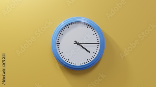 Glossy blue clock on a orange wall at quarter past four. Time is 04:15 or 16:15