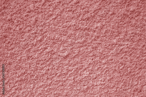 Texture of a pink rough concrete wall
