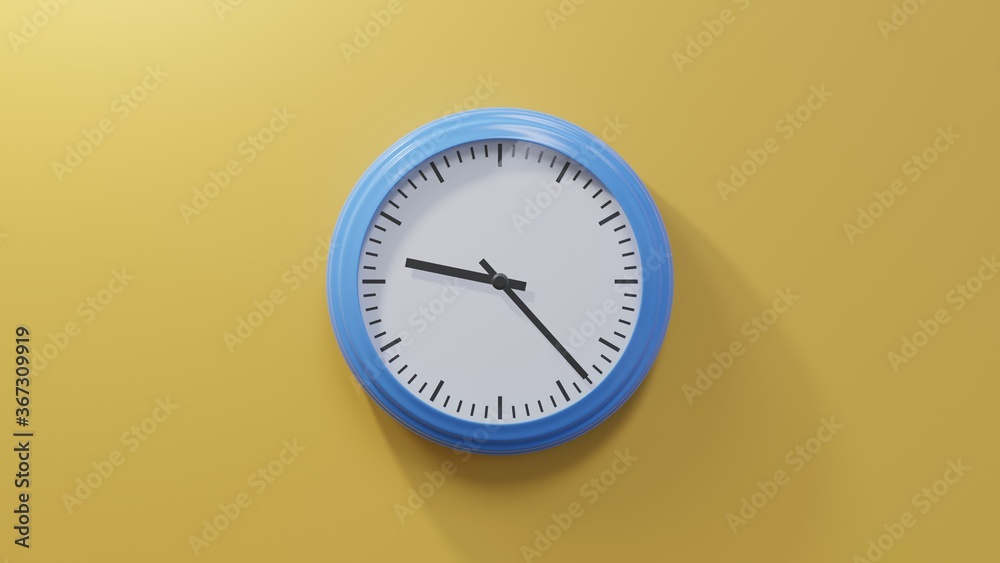 Glossy blue clock on a orange wall at twenty-three past nine. Time is 09:23 or 21:23
