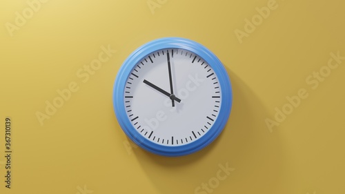 Glossy blue clock on a orange wall at fifty-nine past nine. Time is 09:59 or 21:59