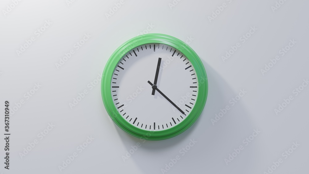 Glossy green clock on a white wall at twenty-two past twelve. Time is 00:22 or 12:22 Glossy green clock on a white wall at twenty-two past twelve. Time is 00:22 or 12:22