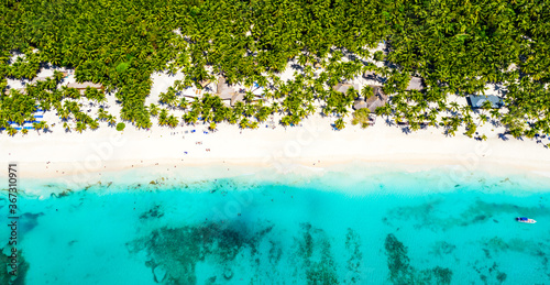 Fototapeta Naklejka Na Ścianę i Meble -  Top aerial drone view of beautiful beach with turquoise sea water, boats and palm trees. Saona island, Dominican republic. Paradise tropical island nature background