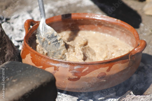 cooking beans in a traditional Mexican way in a clay pot