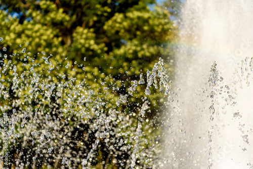 Selective focus on spray of urban fountain and blurred background