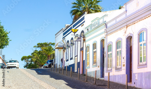 Colorful painted houses in a row in the typical street of Lagos, Portugal. 