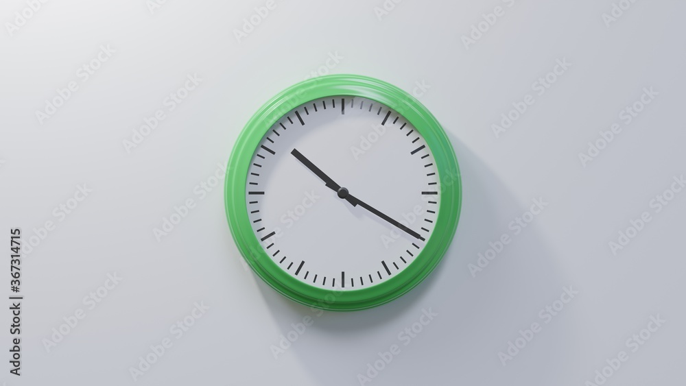 Glossy green clock on a white wall at twenty past ten. Time is 10:20 or 22:20 Glossy green clock on a white wall at twenty past ten. Time is 10:20 or 22:20