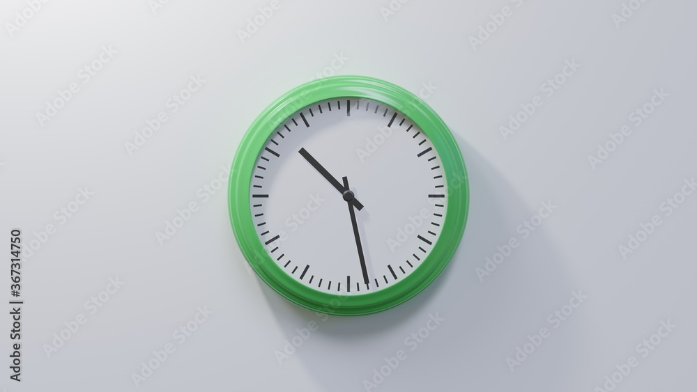 Glossy green clock on a white wall at twenty-eight past ten. Time is 10:28 or 22:28