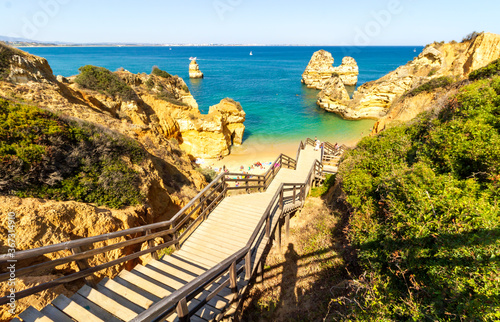 Fototapeta Naklejka Na Ścianę i Meble -  Beautiful scenery of the famous Camilo beach in Algarve, South of Portugal in the end of the day. 