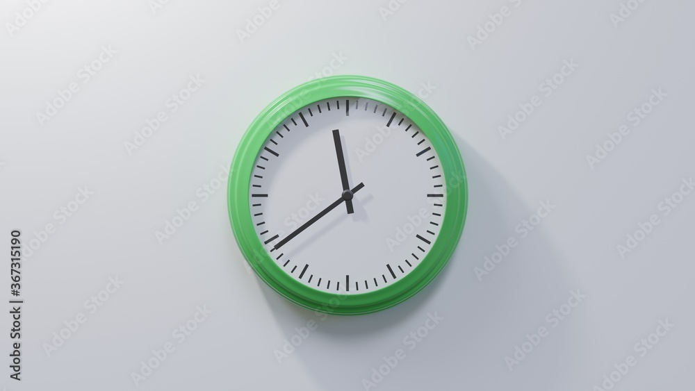 Glossy green clock on a white wall at thirty-nine past eleven. Time is 11:39 or 23:39 Glossy green clock on a white wall at thirty-nine past eleven. Time is 11:39 or 23:39
