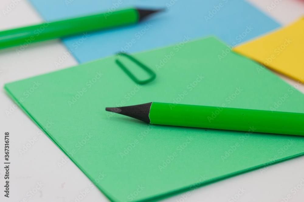 colored stickers note paper and pencil on a white background colored stickers note paper and pencil on a white background