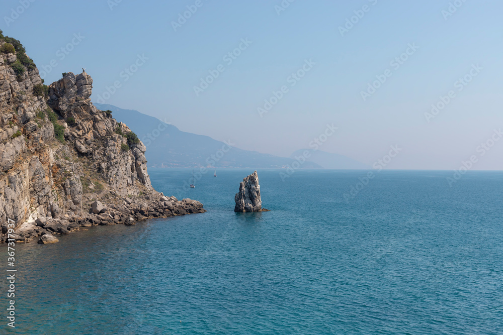 Rock Sail, Yalta, southern coast of Crimea. Calm blue sea and clear sky on the background. Summer vacation concept