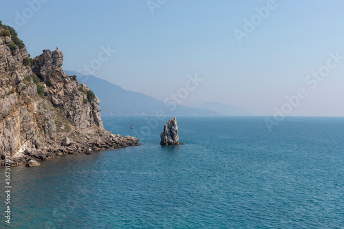 Rock Sail, Yalta, southern coast of Crimea. Calm blue sea and clear sky on the background. Summer vacation concept