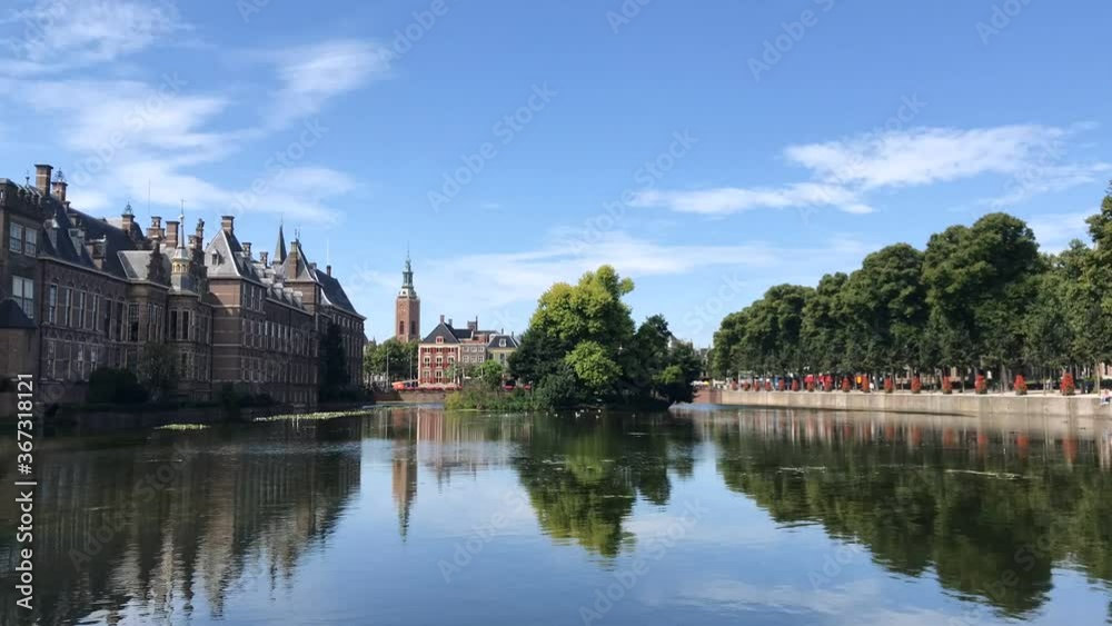 Hofvijver reflection, the Dutch parliament building with Den Haag city scape in the background and the winds blowing the pond surface creating waves under a beautiful sunny spring, Netherlands Hofvijver reflection, the Dutch parliament building with Den Haag city scape in the background and the winds blowing the pond surface creating waves under a beautiful sunny spring, Netherlands