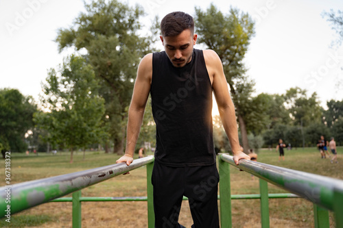 Man exercising in the park on bars  © phoenix021