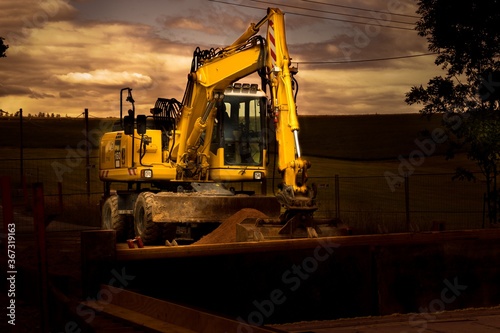 Excavator with shovel in the dark