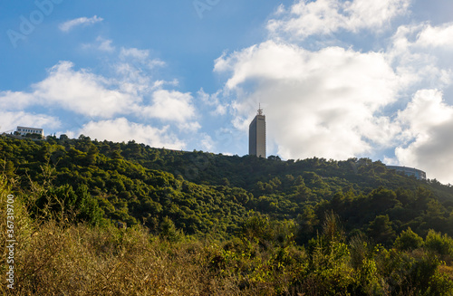 View of the  building of the Haifa Technion standing on a wooded mountainside from the public Nesher Park suspension bridges in Nesher city in northern Israel photo