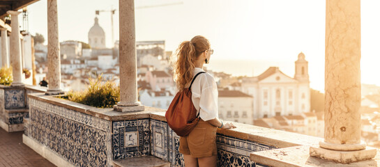 Person looking at breathtaking view of the city in Europe during the sunset