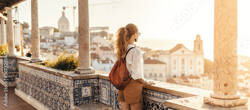 Person looking at breathtaking view of the city in Europe during the sunset © seligaa
