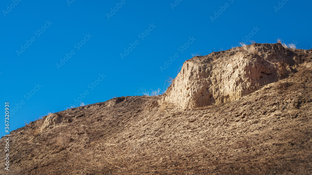 Clay mountain against the blue sky. Clay mountain against the blue sky.