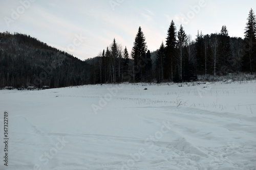 Mountain winter landscape of a snowy valley. Snowy winter mountains. The cold Siberian climate.