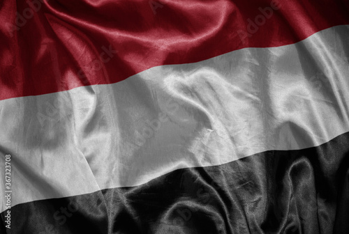 colorful shining big national flag of yemen on a silky texture