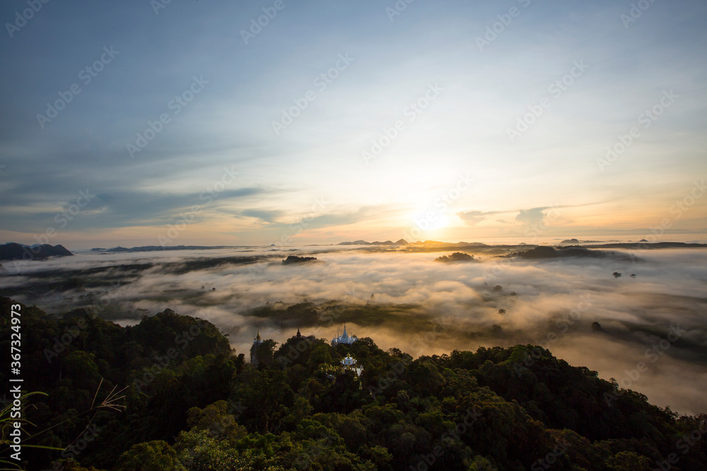 Amazing sunrise over misty landscape. Scenic view of foggy morning sky. Landscape sea of misty in dawn morning sunrise time at  Khao Na Nai Luang Dhrama  Park, Surat Thani province,Thailand