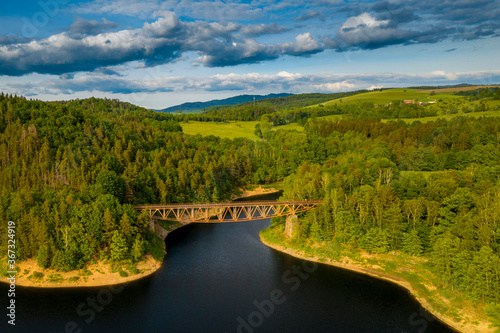 Aerial view of old, historic steel underspanned suspension railway bridge over Bobr River in Pilchowice, Lower Silesia, Poland. Concept of industrial epoque photo