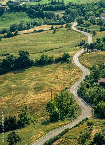 Hilly curvy road without traffic through the hills of the Northern Apennines. Bardi, Parma province, Emilia Romagna, Italy.