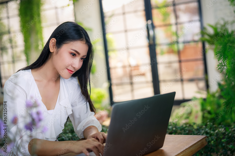 Asian female freelancer working from home with labtop computer Asian female freelancer working from home with labtop computer