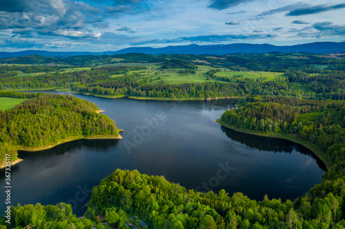 Aerial view of beautiful lake with islands and green forests near Karkonosze Mountains on a sunny summer day in Pilchowice  Lower Silesia  Poland. Drone photography