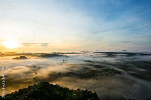 Beautiful sunrise with sea of misty in dawn morning on the top of Khao Na Nai Luang Temple Park, Surat Thani province,Thailand